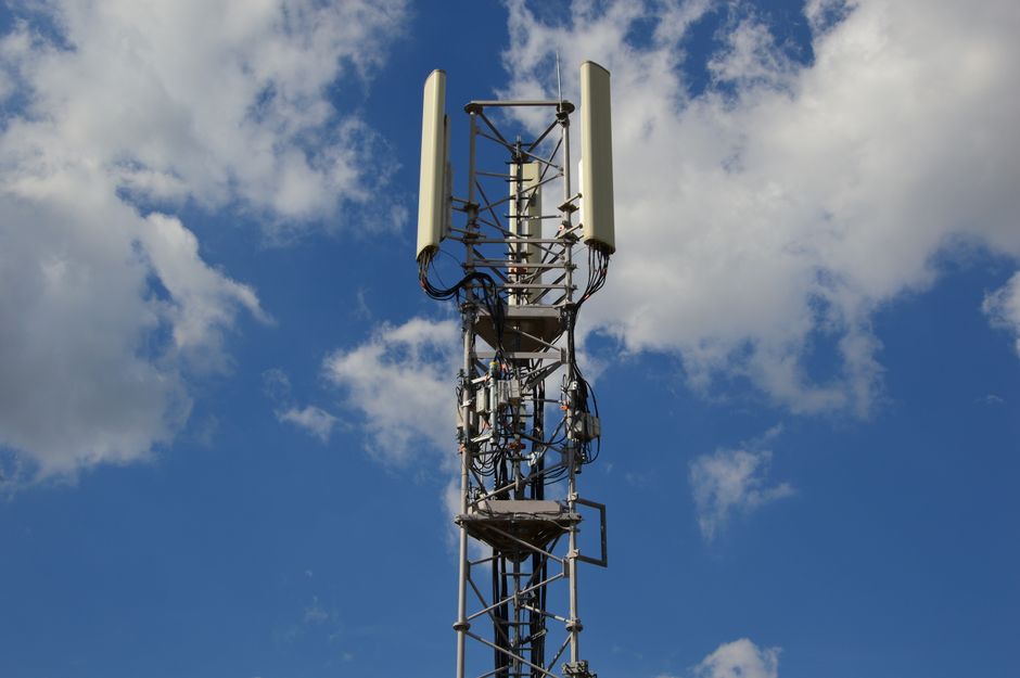 Cellular network tower against a blue sky